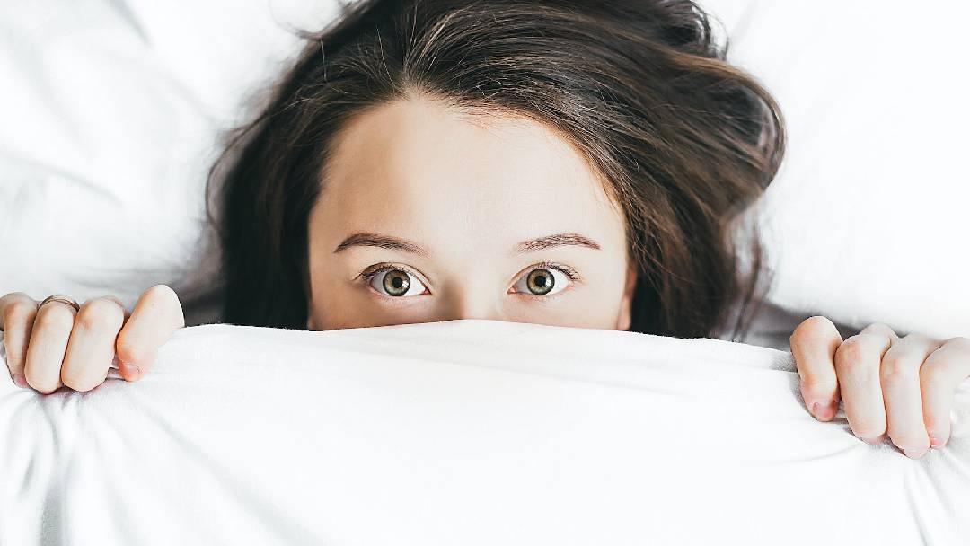 Woman In Bed Having Trouble Falling Asleep