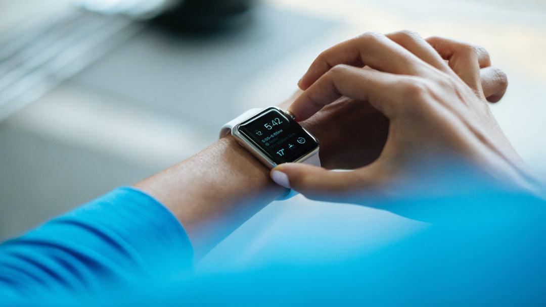 A man looking at his smartwatch