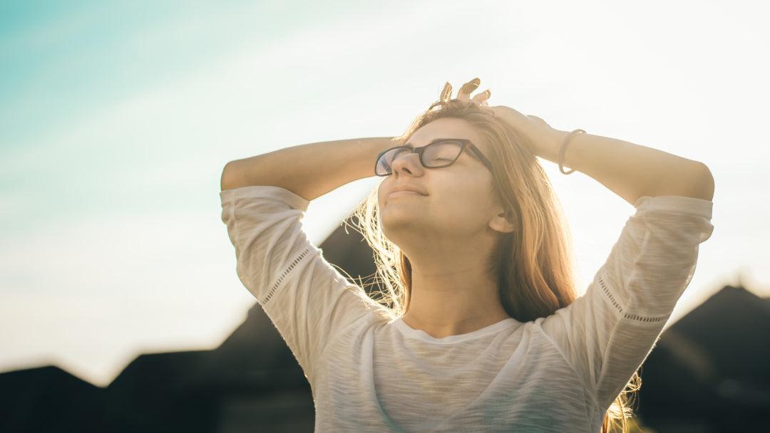 A smiling, relaxed woman in the sun